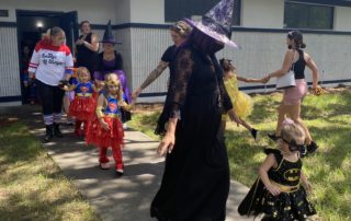 children walking with their halloween costumes