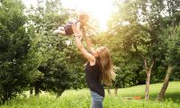 thum- women tossing baby in air